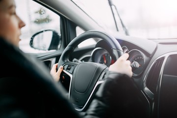 Naklejka premium girl driving a car. modern interior.