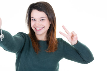 Cute woman making selfie photo in white background