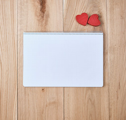 notebook with a cell with empty sheets and red heart
