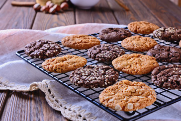 Thin, tasty, crunchy chocolate and caramel cookies on a black metal grid
