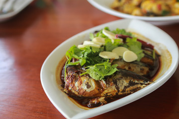 Boiled Mackerel with secrete sauce - PHATOO SATEA is Thai seafood- serve in white plate.