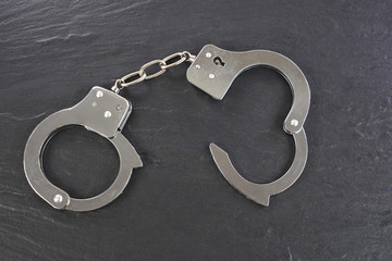 Handcuffs  on black background .