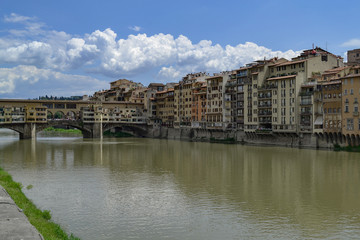 Fototapeta na wymiar The Ponte Vecchio is a medieval stone closed-spandrel segmental arch bridge over the Arno River, in Florence, Italy, noted for still having shops built along it, as was once common.