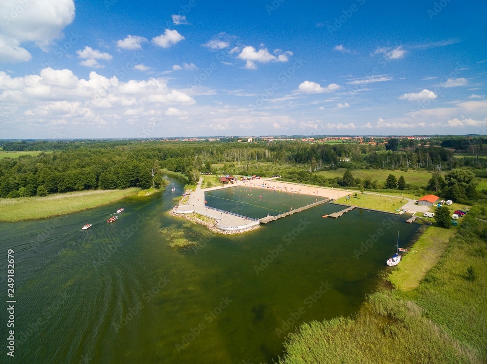 Poster aerial view of yachts sailing on mamry lake, concrete quay and town beach, wegorzewo, mazury, poland