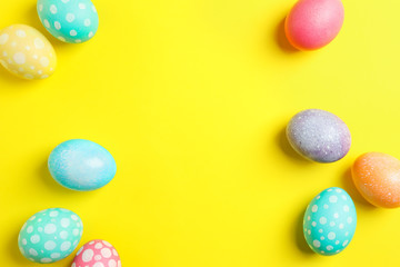 Colorful easter eggs on yellow background. Space for text