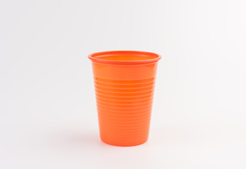 Empty orange plastic cup isolated on white