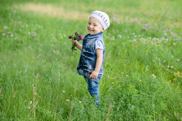 Cute baby girl with spring flowers