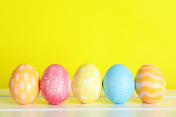 Decorated Easter eggs on color background, closeup. Space for text