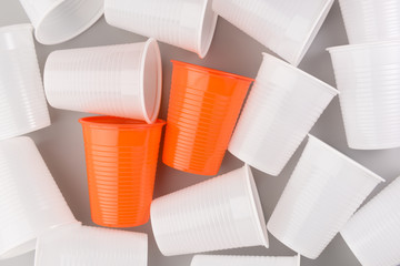 Disposable plastic cups isolated on grey background, pollution concept