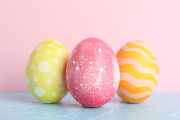 Decorated Easter eggs on color background, closeup. Space for text