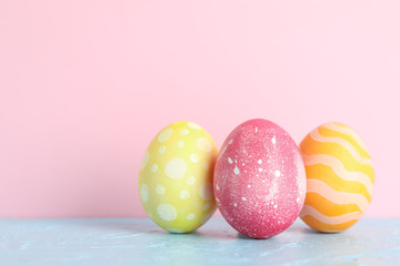 Decorated Easter eggs on color background, closeup. Space for text
