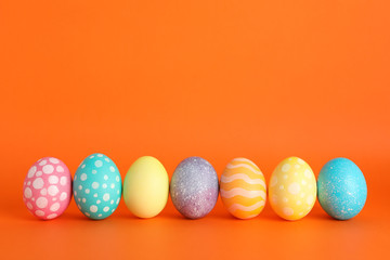 Decorated Easter eggs on color background. Space for text