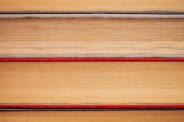 Vintage books close-up. Stack of used old literature in school library. Background from old chaotic reading matter. Dusty faded books horizontally with copy space. Old book store.