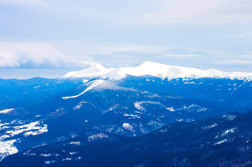 mountains in the snow on a background of clouds in the winter
