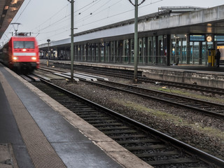 Fototapeta na wymiar red train entering train station