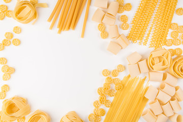 An overhead photo of different types of pasta, including spaghetti, penne, fusilli, and others,...