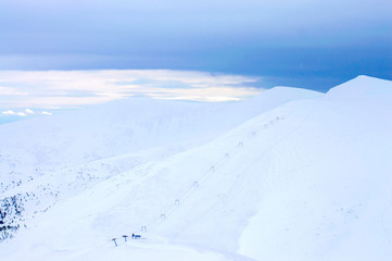 mountains in the snow on a background of clouds in the winter