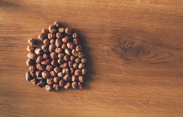 Pile of hazelnuts on wooden background