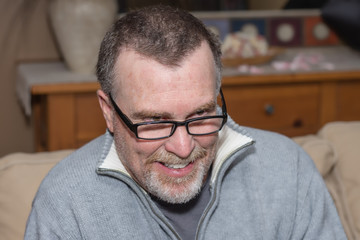 Obraz premium senior man reading an old book looks down