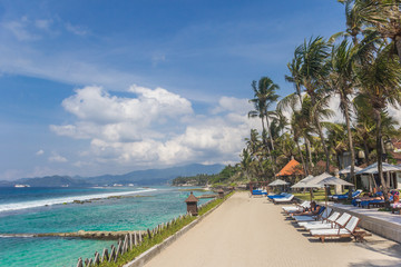 Sunbeds at a hotel on the Candidasa coast of Bali, Indonesia
