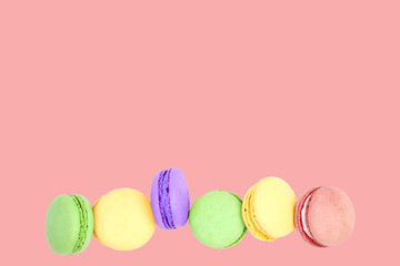 Delicious macarons on pink background