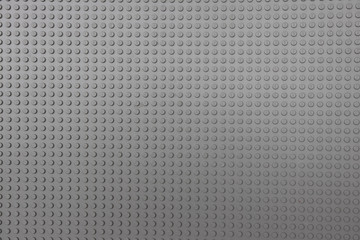 background. Gray plastic game board for a children's designer.