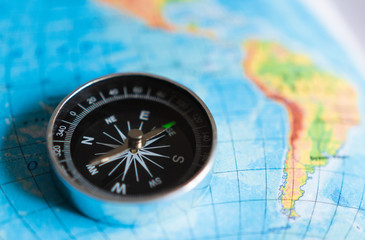 blue world map background. compass for traveling and hiking