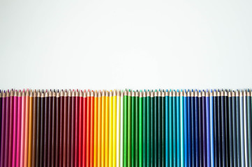Many multi-colored pencils. Background with color pencils. Rainbow colors, palette. Bright and colorful backgrounds.