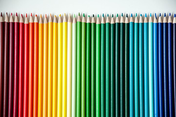 Many multi-colored pencils. Background with color pencils. Rainbow colors, palette. Bright and...