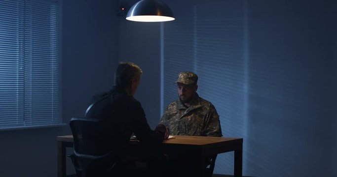 Policeman interrogating a soldier