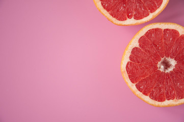 Citrus grapefruit on a pink background in a cut