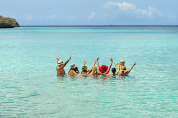 Group of middle aged people posing for group photo inside the sea