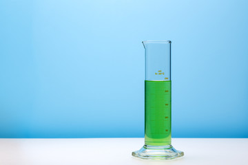 Laboratory graduated cylinder with green liquid