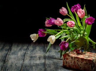 Beautiful bouquet of of colorful tulips on dark background. Spring flowers for Mother's Day, International Women's Day, birthday