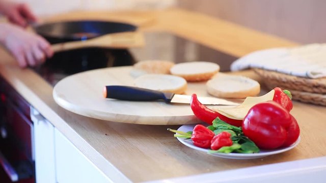 candind view at grilled mear and bun white cooking hamburger at home.