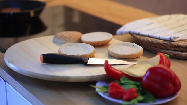 candind view at grilled mear and bun white cooking hamburger at home.