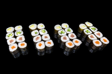 various hosomaki sushi combo set with salmon tuna cucumbers avocado on a black background 