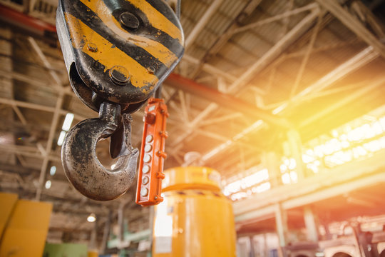 Crane chain and hook blurred warehouse background with remote control. Concept production steel factory - Powered by Adobe