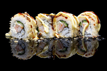Uramaki Sushi with ebi shrimp and tempura on a black background