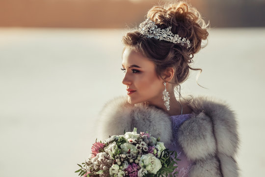 Luxury portrait of beautiful caucasian bride in wedding fashionable dres and crown and jewelery with diamonds. Winter, wedding, lixury concept
