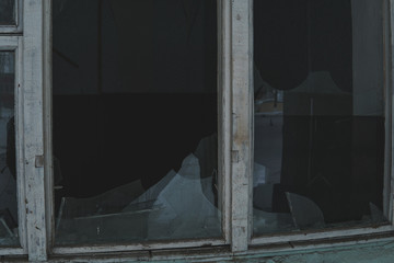 Broken window in an abandoned building. Broken glass