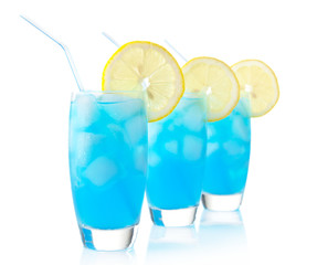 Blue lagoon drinks with slice of lemon with straw isolated on white