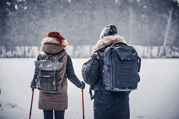 Couple walks and trains in winter near the forest