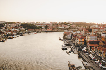 Fototapeta na wymiar Porto cityscape with red roofs and river while sunset
