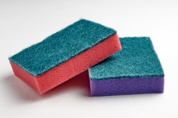 Multi-colored sponges for washing dishes on a light background close-up