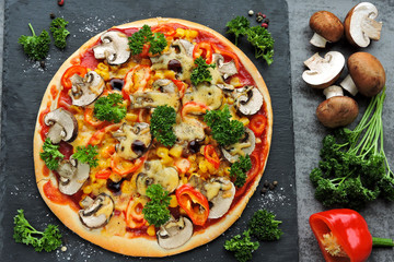 Vegan pizza with vegetables and mushrooms. The concept of healthy food without meat.
