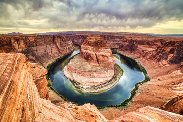 Horseshoe Bend on Colorado River at Sunset with Dramatic Cloudy Sky, Utah