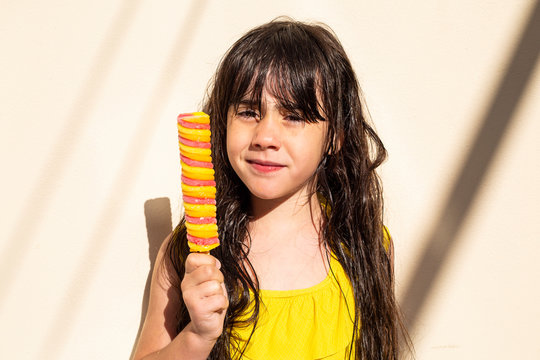 Portrait of little girl with popsicle