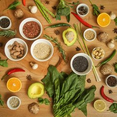Variety of herbs, spices, fruits and vegetables on the wooden table