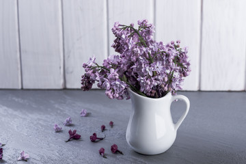 Bouquet of purple lilacs flowers on a vase.
